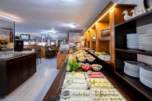 
a kitchen filled with lots of plates of food at Kozan City Hotel in İzmir
