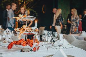 a table with several plates of food and wine glasses at Villa Fridhem Boutiquehotell in Åby