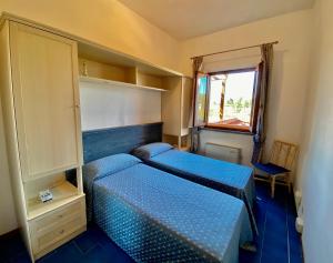 Postel nebo postele na pokoji v ubytování RESIDENCE TERME ISOLA D'ELBA SRL