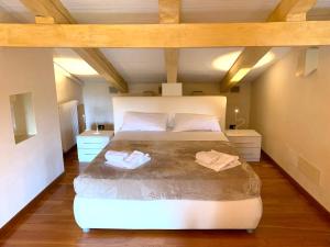 a bedroom with a large white bed in a attic at Tenuta Santa Lucia in Silea