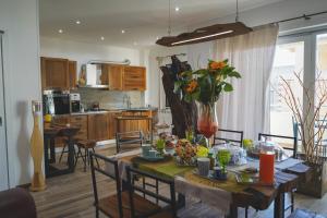 a kitchen and dining room with a table and chairs at Ulivo Design b&b in Reggio di Calabria