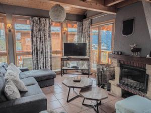 a living room with a couch and a fireplace at The Hunting Lodge in Landry +7 photos