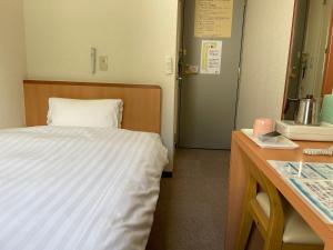 Postel nebo postele na pokoji v ubytování Kur and Hotel Isawa