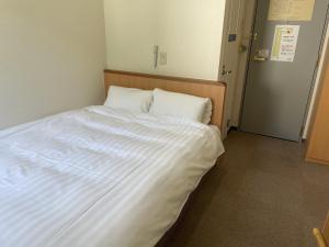 Postel nebo postele na pokoji v ubytování Kur and Hotel Isawa