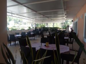 a dining room with tables and chairs and a unintention at Pansion restoran Marin in Posedarje
