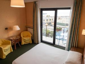 a hotel room with a bed and a large window at Hotel Santa Maria in Chiavari