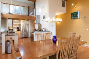 a kitchen and dining room with a wooden table and chairs at Mountain House home in Mount Hood