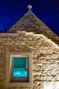 una ventana en un edificio de piedra con techo en VERDEACQUA SUITE en Locorotondo