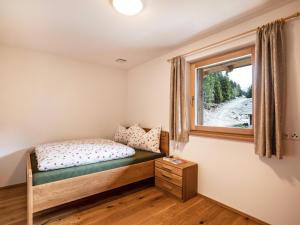 un dormitorio con una cama y una ventana en Pfattenspitz Maurerhof, en Valdurna