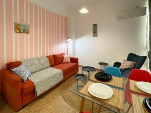 a living room with a couch and a table at SOHO Vibrant 55sqm apt in Athens in Athens