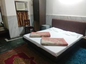 a bed with two pillows on it in a room at Hotel Prince in Guwahati