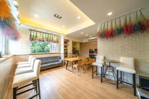 a living room with chairs and tables and a brick wall at Caspia in Wujie