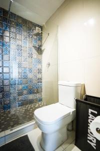 a bathroom with a toilet and a glass shower at Ocean blues Isikhulu 7 in Umdloti