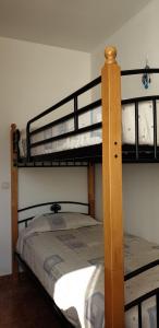 a bedroom with two bunk beds in a room at Villa Ghìo in Caleta De Fuste