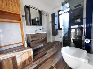 a bathroom with a toilet and a sink and a mirror at Casa Vacanze - Casa Quattro Luci in Tronzano Lago Maggiore
