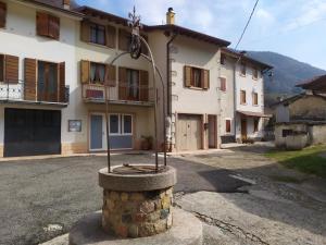a building with a street light in front of it at B&B In Contrá in Selva di Progno