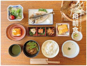 a table with plates of food and bowls of food at Hotel & Resort Kiyomizu Bozanso in Yamanouchi