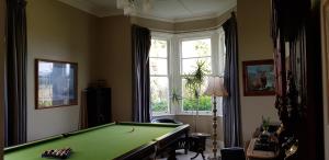 a room with a pool table and a window at Estancia farm stay in Masterton