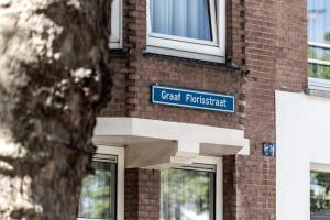 a blue sign on the side of a brick building at Le Petit Marin Boutique Hotel in Rotterdam