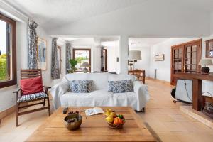 シントラにあるALTIDO 3-BR Cottage with Terrace and Garden in Colaresのリビングルーム(白いソファ、テーブル付)