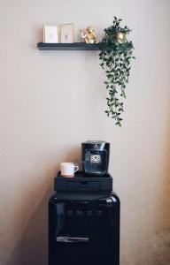 a table with a clock and a plant on a wall at Van der Valk Hotel Hildesheim in Hildesheim