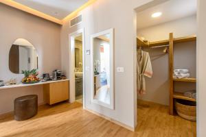 a bathroom with a sink and a mirror at Stella Palace Aqua Park Resort in Hersonissos