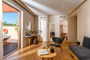 a living room with a couch and a table at Stella Palace Aqua Park Resort in Hersonissos