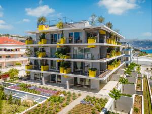 an apartment building with balconies and plants at Amphora's Garden in Split