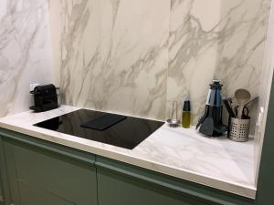 a kitchen with a counter top with a sink at Appartement l'émeraude à Saint Malo Intra-Muros in Saint Malo +49 photos