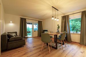 a living room with a table and chairs and a couch at Ferienwohnung Pölzl in Chieming