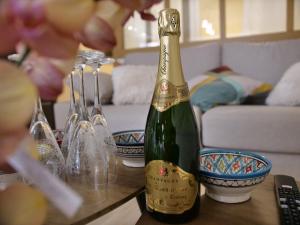 a bottle of champagne sitting on top of a table at Plage à 50m Appartement Rêves de plage Villa Les Bains de Mers in Mers-les-Bains