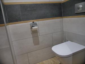 a bathroom with a toilet and a toilet paper dispenser at Plage à 50m Appartement Rêves de plage Villa Les Bains de Mers in Mers-les-Bains