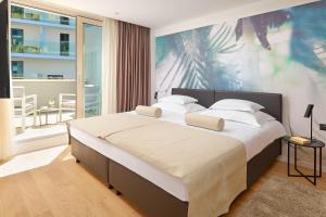a bedroom with a large bed with a large painting on the wall at Amphora's Garden in Split