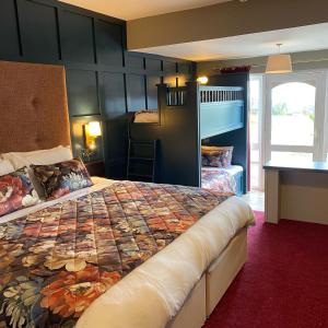 a bedroom with a large bed and a bunk room at Towers Hotel Glenbeigh in Glenbeigh