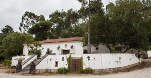 an old white house with a gate and stairs at Quinta do Brejo - Turismo Equestre in Mafra