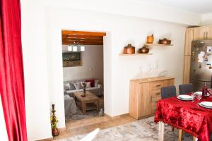 a living room with a table and a couch at Marilou's Cottage in Ágios Matthaíos