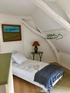 a bedroom with a bed in the attic at La Closerie - trois chambres in Vicq-sur-Gartempe