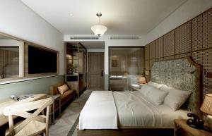 A bed or beds in a room at La Passion Hanoi Hotel & Spa