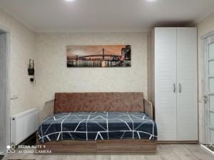 1 dormitorio con 1 cama y una pintura en la pared en Апартаменты студия, 10мин до центра, онкоцентр, томоклиника,, en Kropyvnytskyi