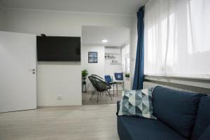 a living room with a couch and a flat screen tv at Landmark 1BDR Apartment in Center, next to Metro in Sofia