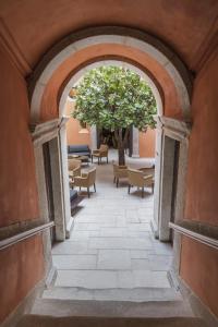 an archway with a tree in a courtyard at Vignette Collection - Casa da Companhia, an IHG Hotel in Porto