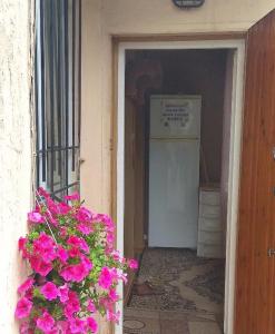 a door leading into a room with pink flowers at Deribasovskaya 16 in Odesa