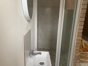 a bathroom with a sink and a shower at Cycad Stay in Mthatha
