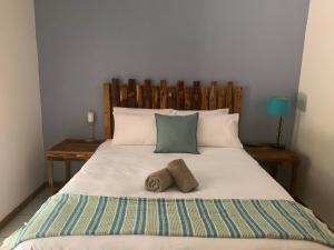 um quarto com uma cama grande com duas toalhas em Cycad Stay em Mthatha