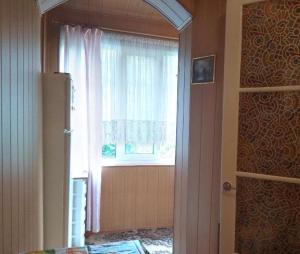 a room with a window and a door with a curtain at Deribasovskaya 16 in Odesa