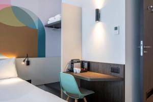 a room with a bed and a desk with a chair at B&B HOTEL Gent Centrum in Ghent