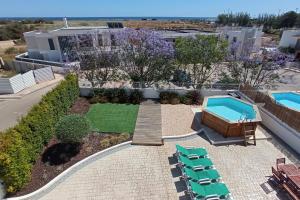 an aerial view of a pool with lounge chairs and a swimming pool at Villa Alvor 7 by amcf in Alvor