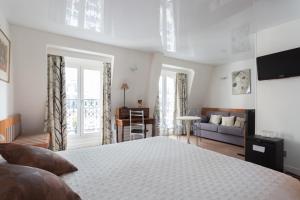 a bedroom with a bed and a living room at HOTEL ALISON in Paris