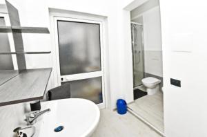 a white bathroom with a sink and a toilet at Borgo 98 Guest House Matrimoniale con bagno privato in Livorno