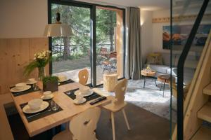 a room with a table and chairs and a living room at Triangel Boutique Hotel in Kranjska Gora